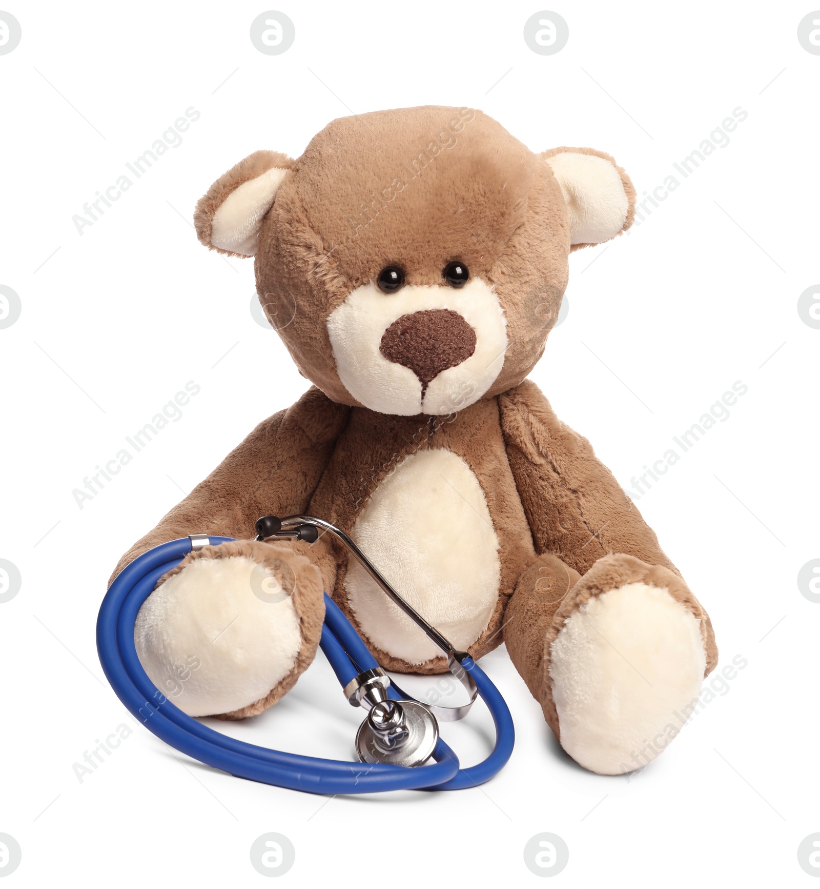 Photo of Pediatrics concept. Teddy bear and stethoscope isolated on white