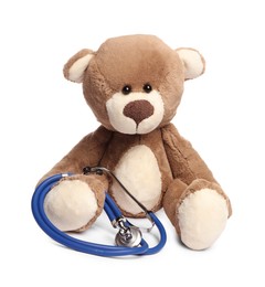 Photo of Pediatrics concept. Teddy bear and stethoscope isolated on white