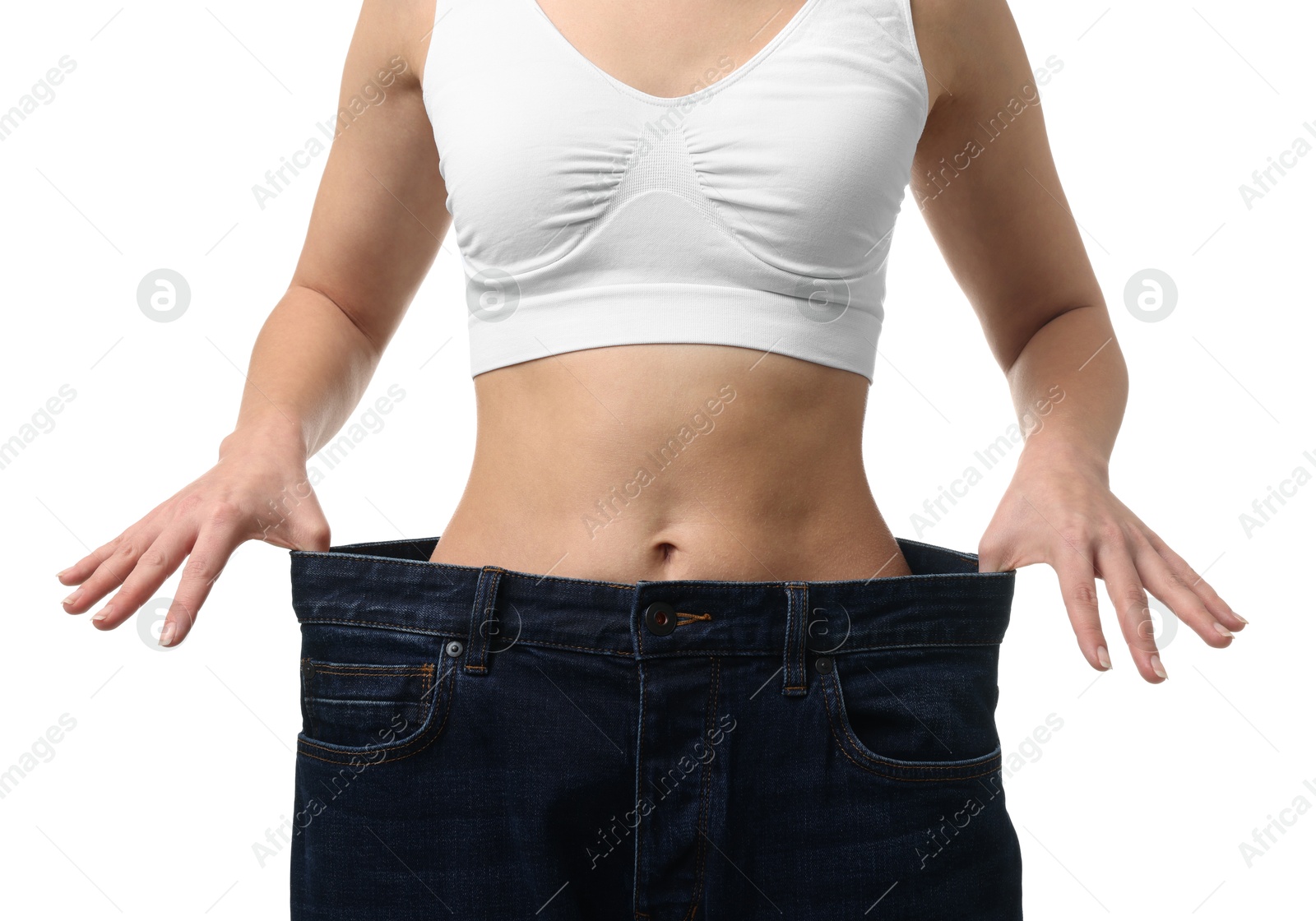 Photo of Weight loss. Woman wearing big jeans on white background, closeup