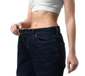 Photo of Weight loss. Woman wearing big jeans on white background, closeup