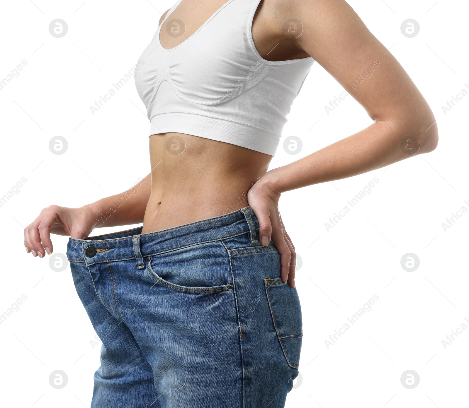 Photo of Weight loss. Woman wearing big jeans on white background, closeup