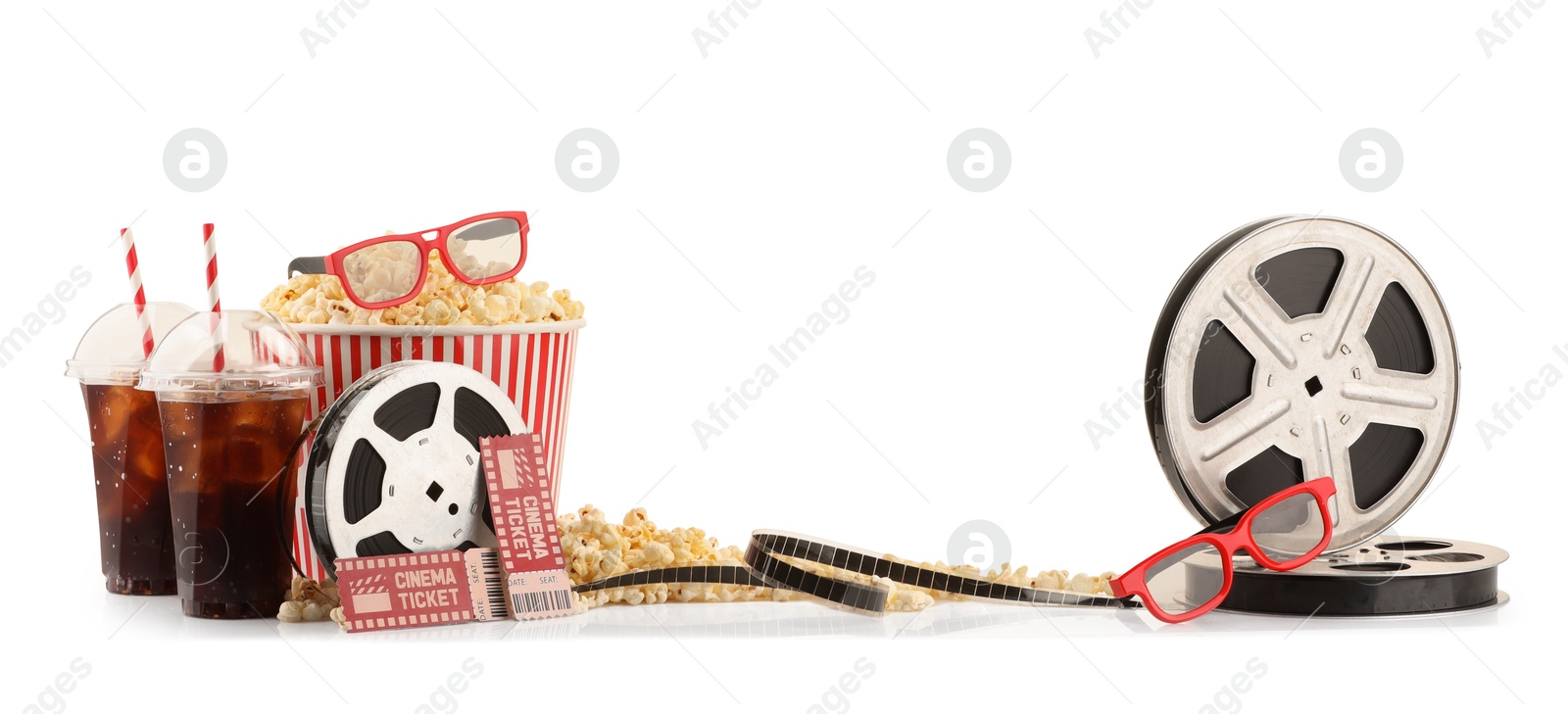 Photo of Tasty popcorn, film reels, soda drinks, glasses and movie tickets isolated on white