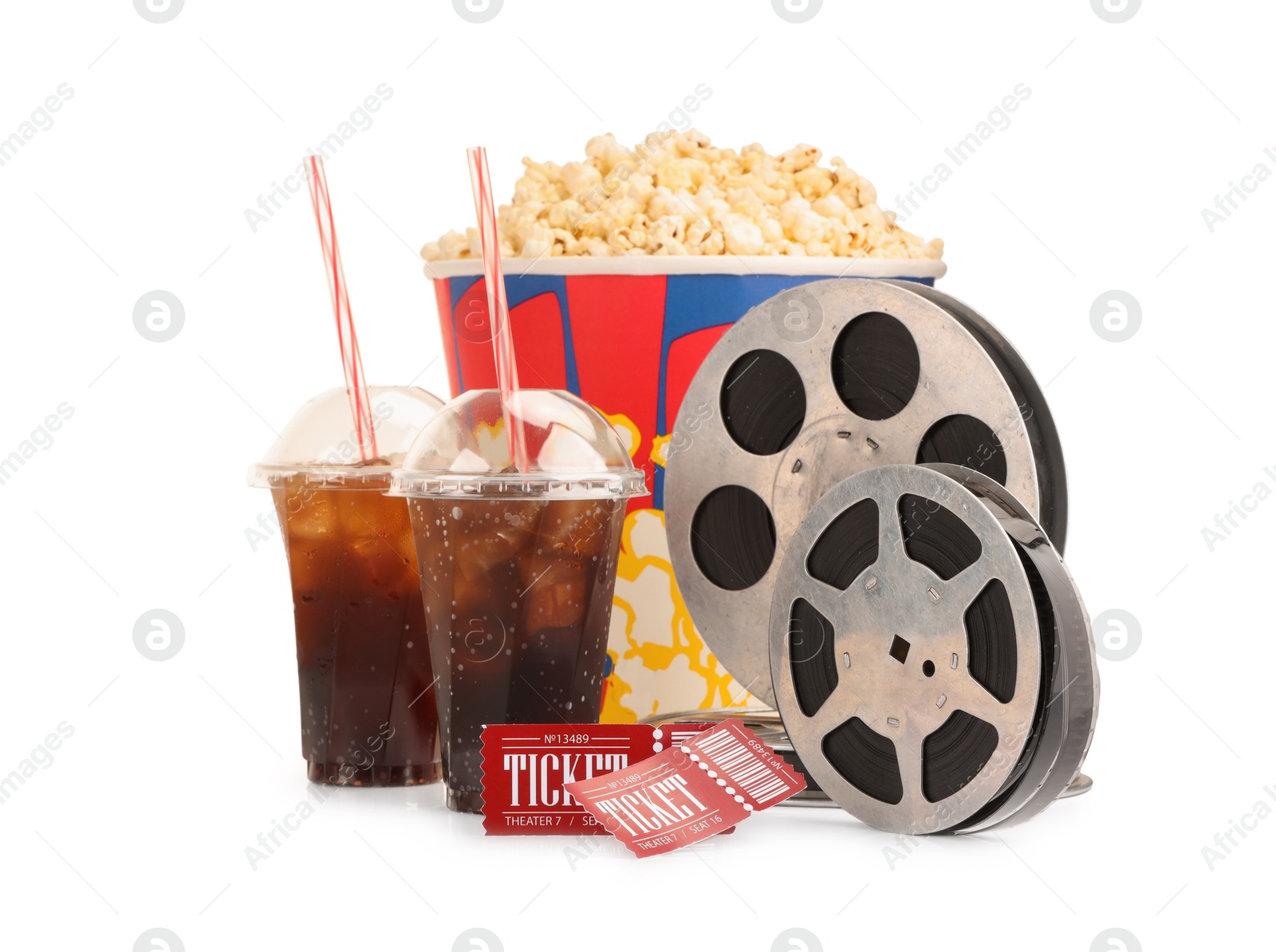 Photo of Tasty popcorn, film reels, soda drinks and movie tickets isolated on white