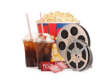 Photo of Tasty popcorn, film reels, soda drinks and movie tickets isolated on white