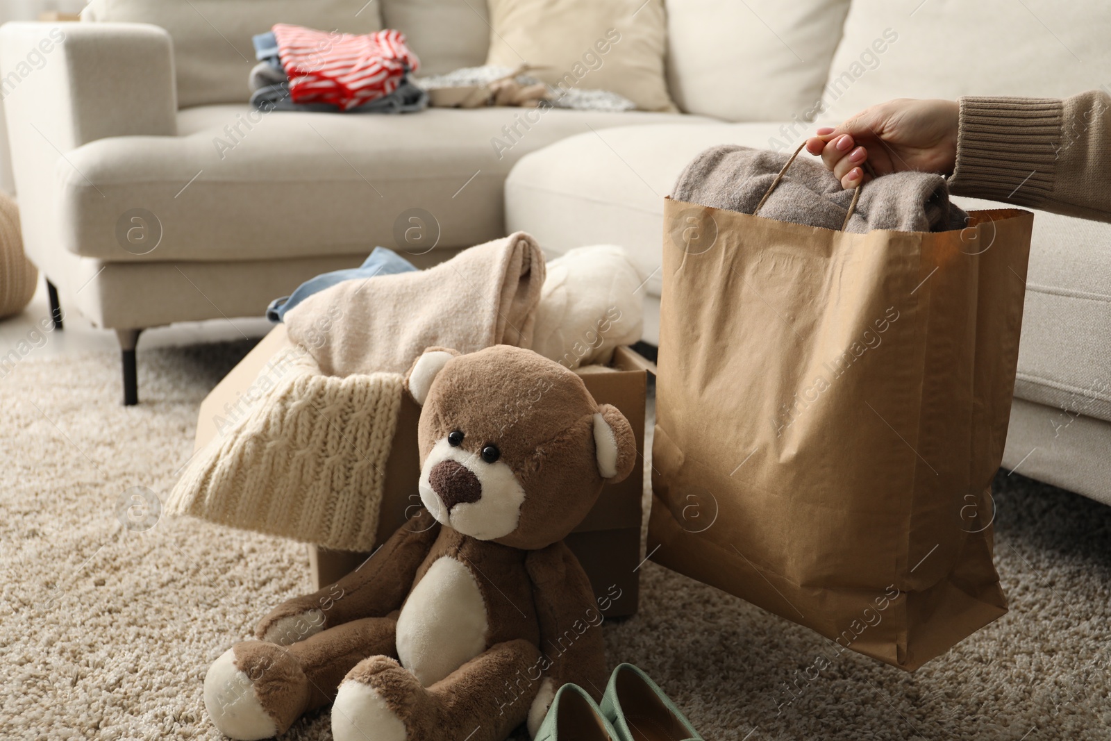 Photo of Woman with different used clothes indoors, closeup