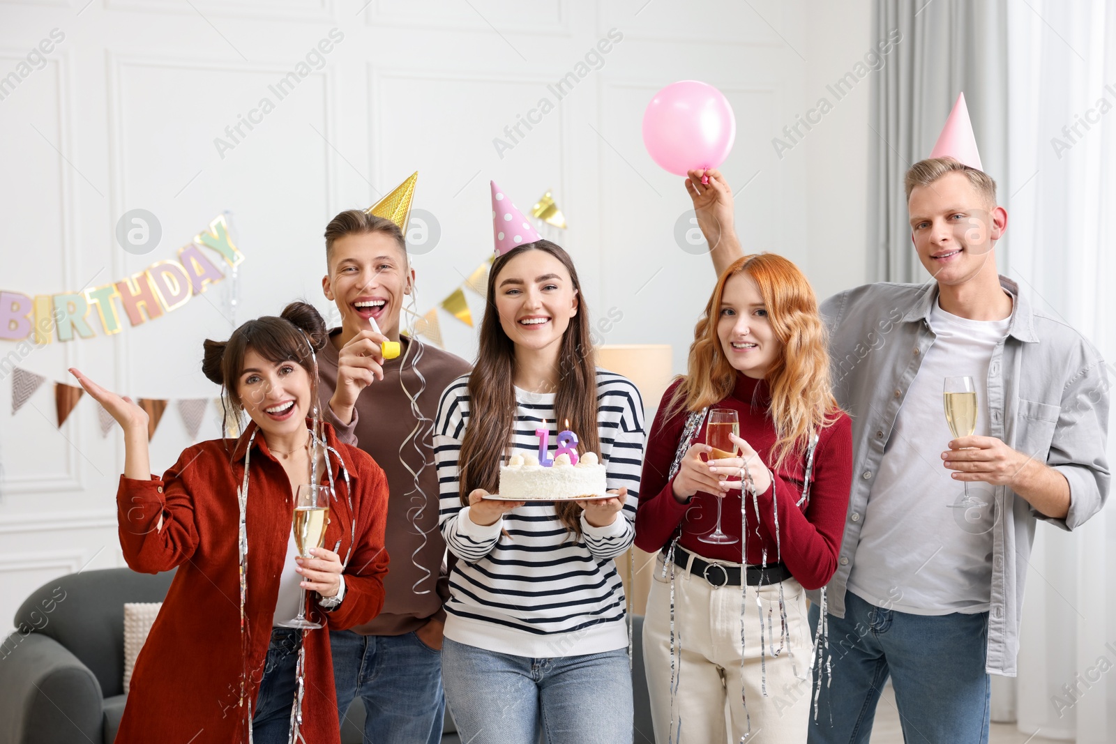 Photo of 18th birthday. Group of happy friends with tasty cake having coming of age party at home