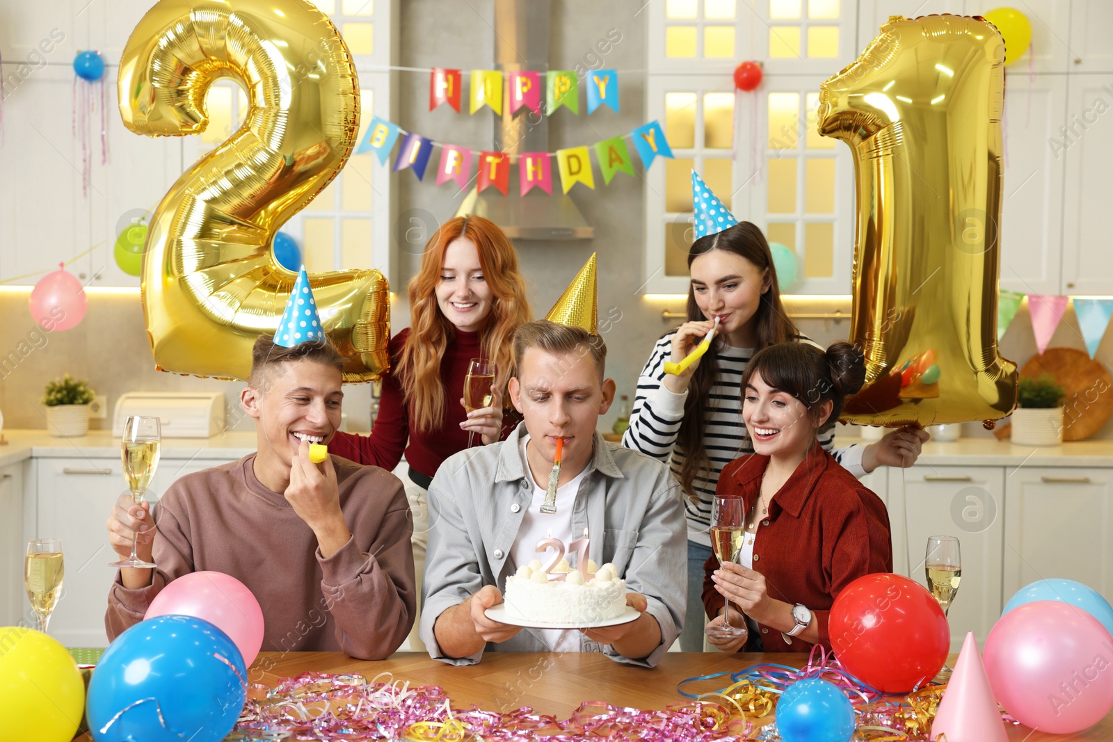 Photo of 21st birthday. Group of happy friends with tasty cake having coming of age party at home