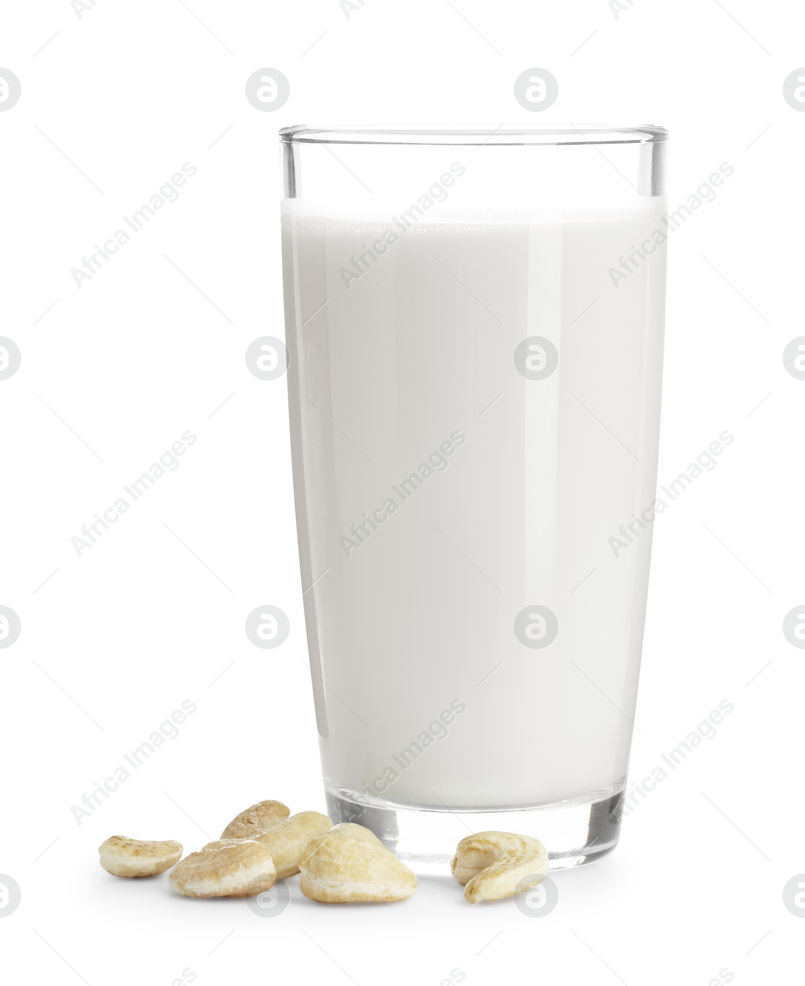 Photo of Fresh cashew milk in glass and nuts isolated on white