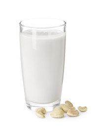 Fresh cashew milk in glass and nuts isolated on white