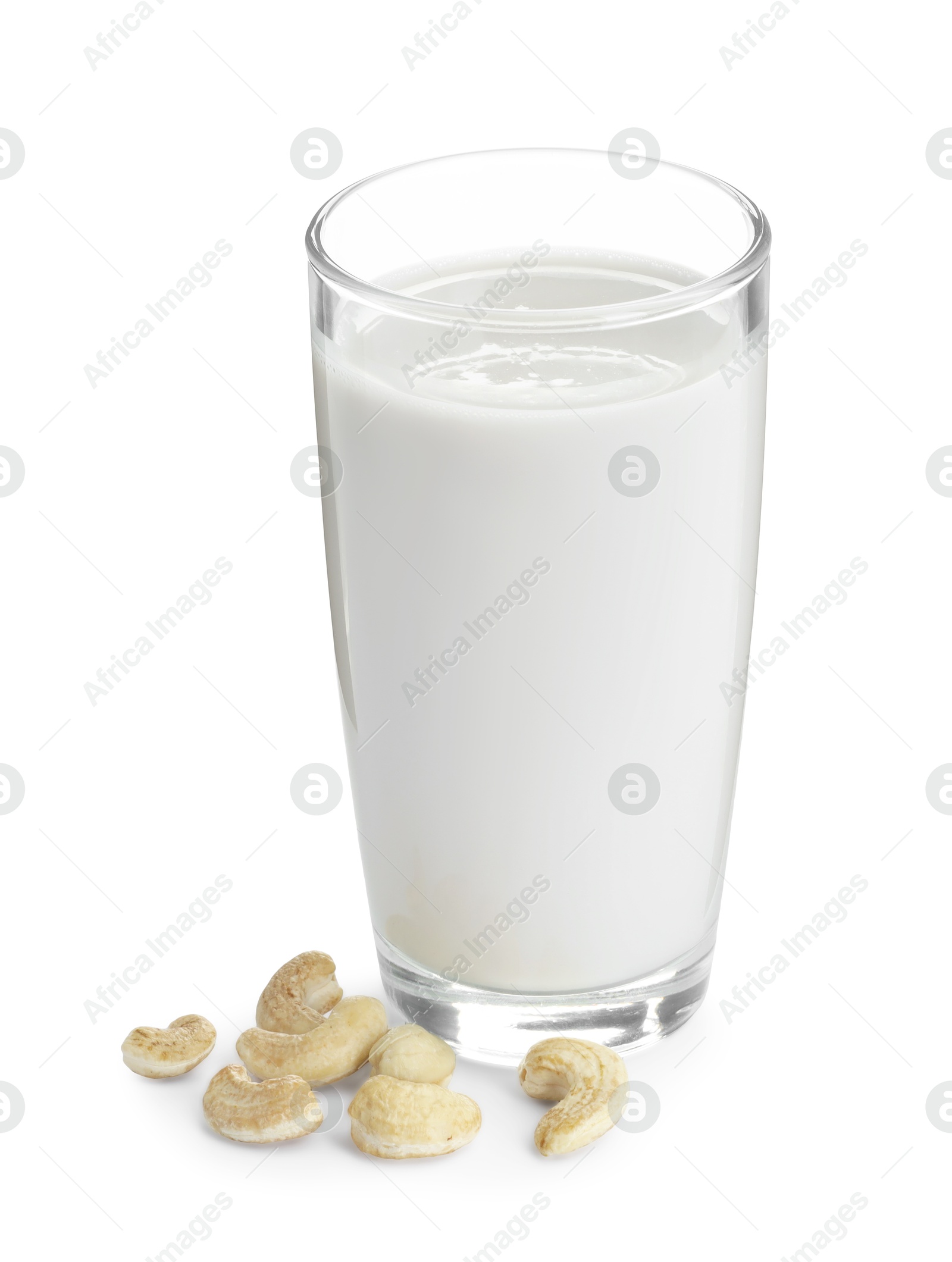 Photo of Fresh cashew milk in glass and nuts isolated on white