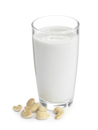 Photo of Fresh cashew milk in glass and nuts isolated on white