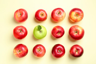 Photo of Red apples and green one on beige background, flat lay