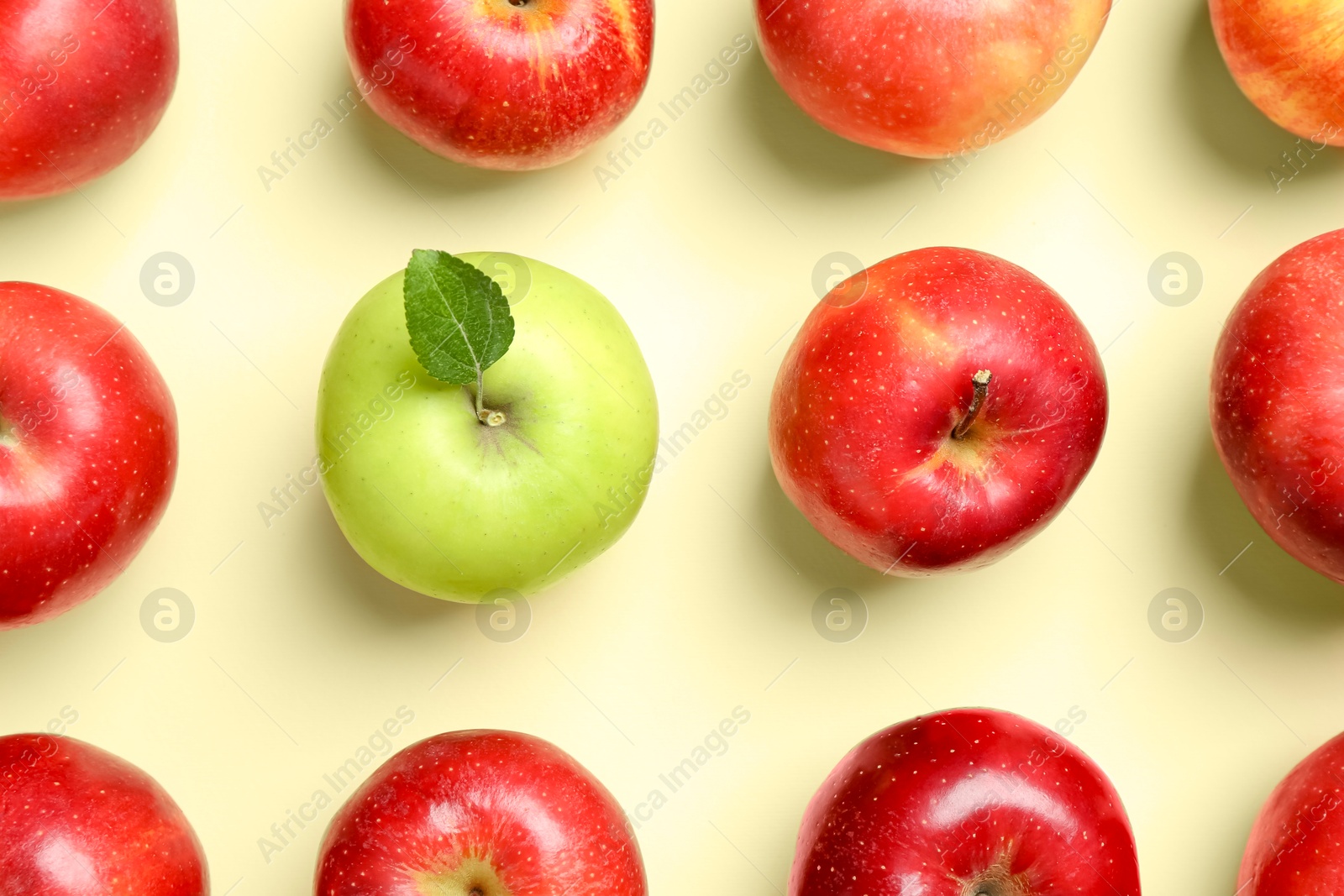 Photo of Red apples and green one on beige background, flat lay