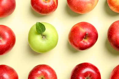 Photo of Red apples and green one on beige background, flat lay