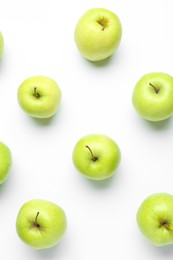 Green apples on white background, flat lay