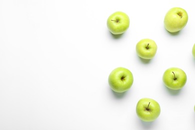 Green apples on white background, flat lay. Space for text