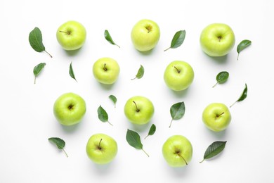 Photo of Green apples and leaves on white background, flat lay