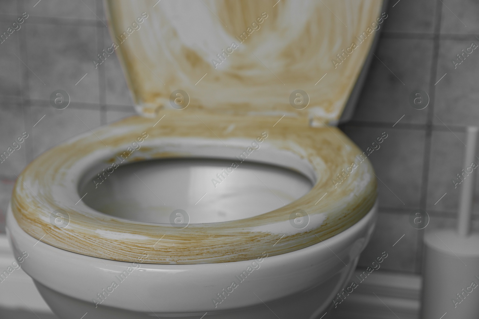 Photo of Toilet with dirty seat in public restroom, closeup