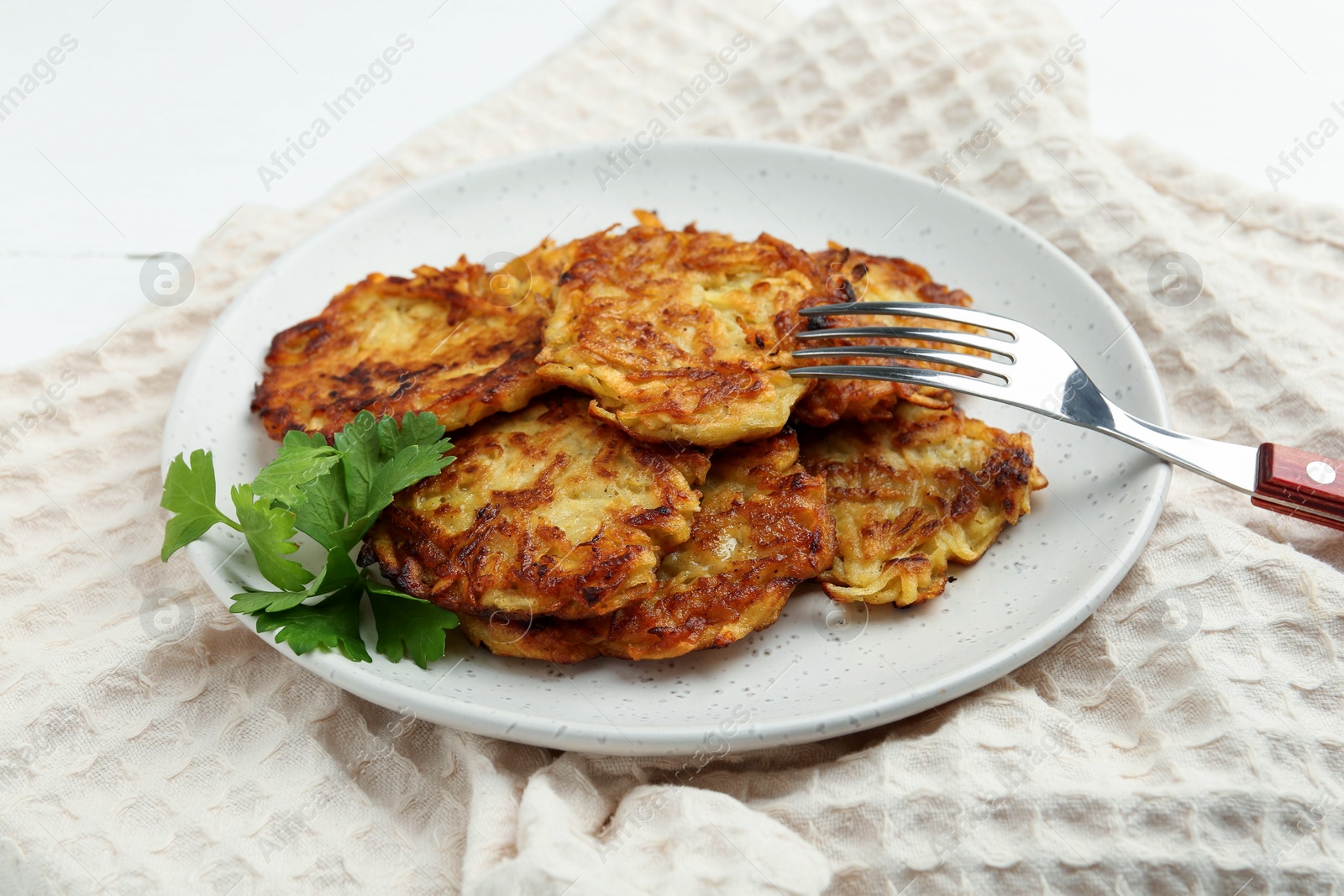 Photo of Delicious potato pancakes served on table, closeup