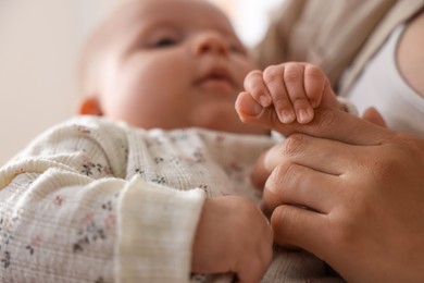 Photo of Mother with her cute little baby at home, closeup