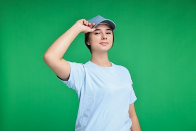 Photo of Girl in uniform on green background. Work for teenagers