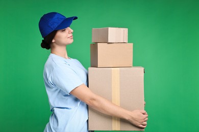 Photo of Girl in uniform with parcels on green background. Work for teenagers