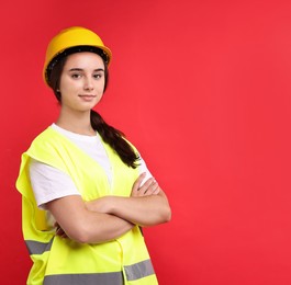 Photo of Girl with safety equipment on red background, space for text. Work for teenagers