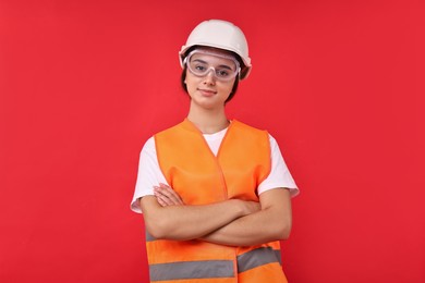 Photo of Girl with safety equipment on red background. Work for teenagers