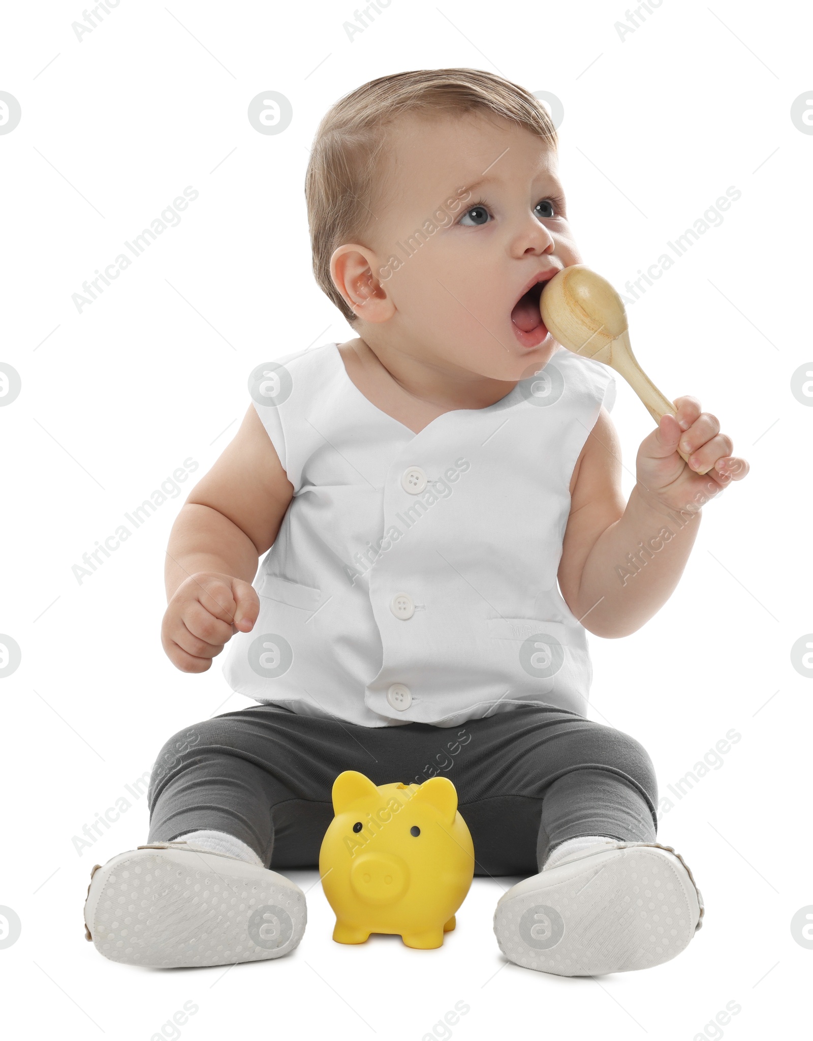 Photo of Little baby with piggybank and toy on white background