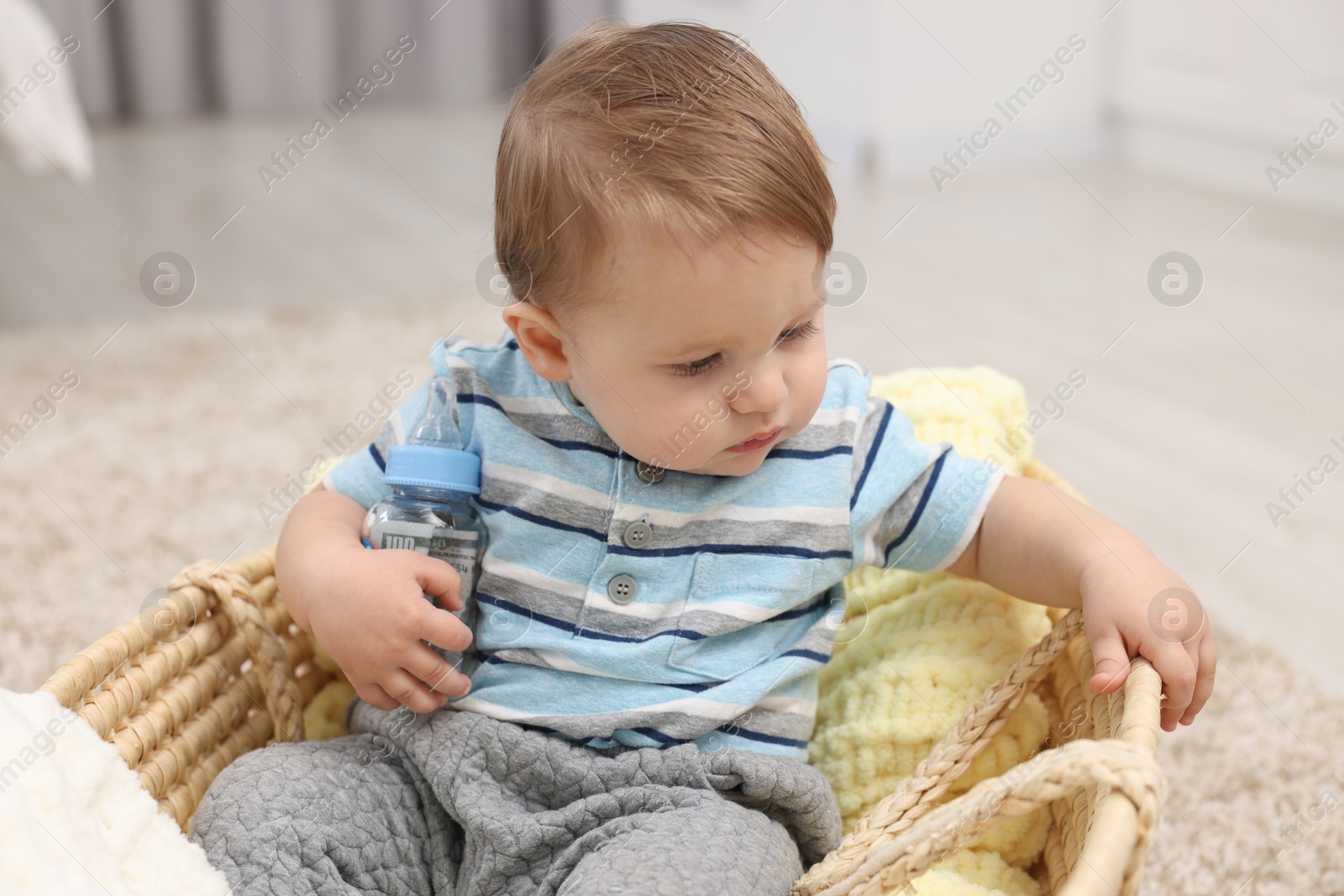 Photo of Little baby with money in bottle at home