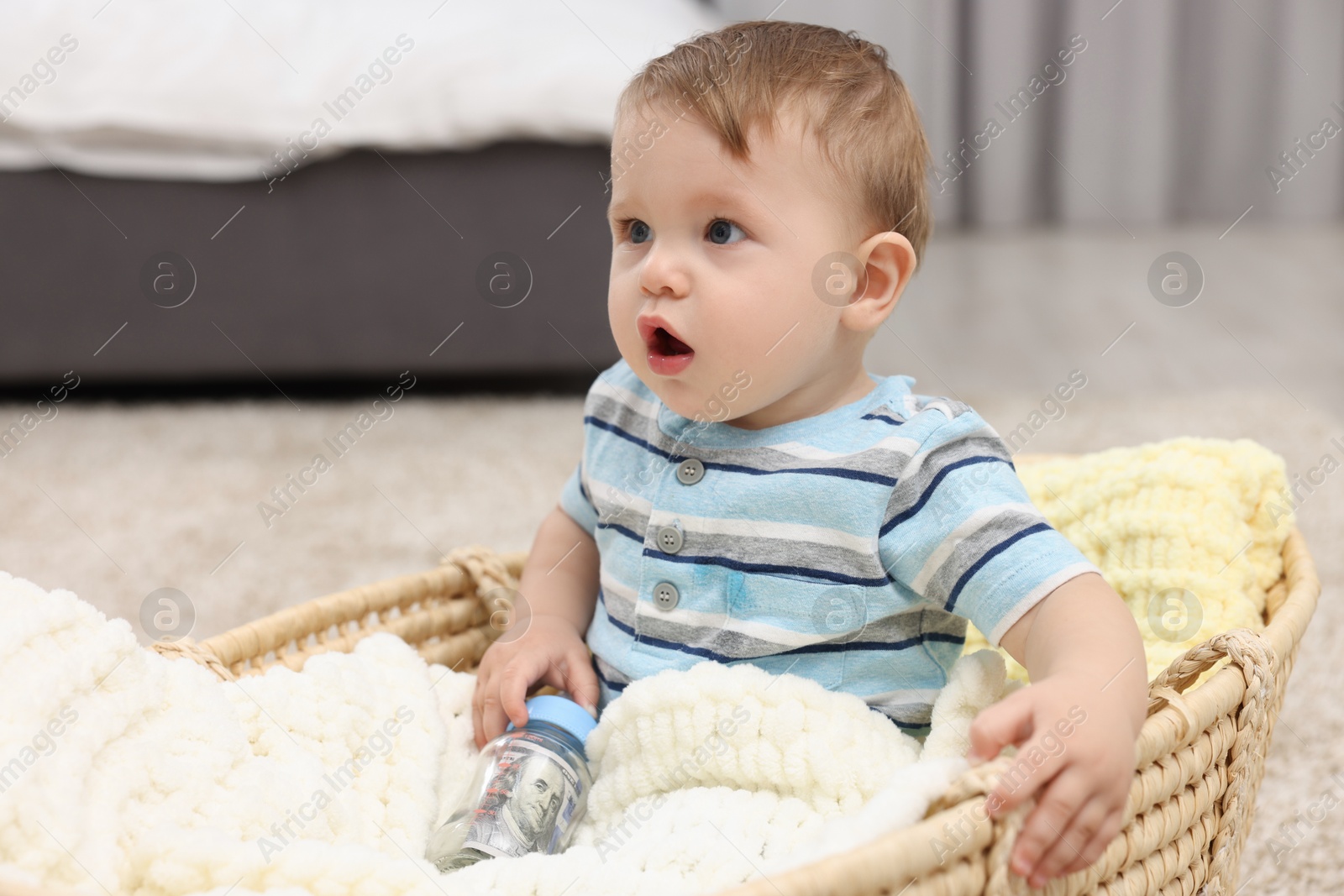 Photo of Little baby with money in bottle at home