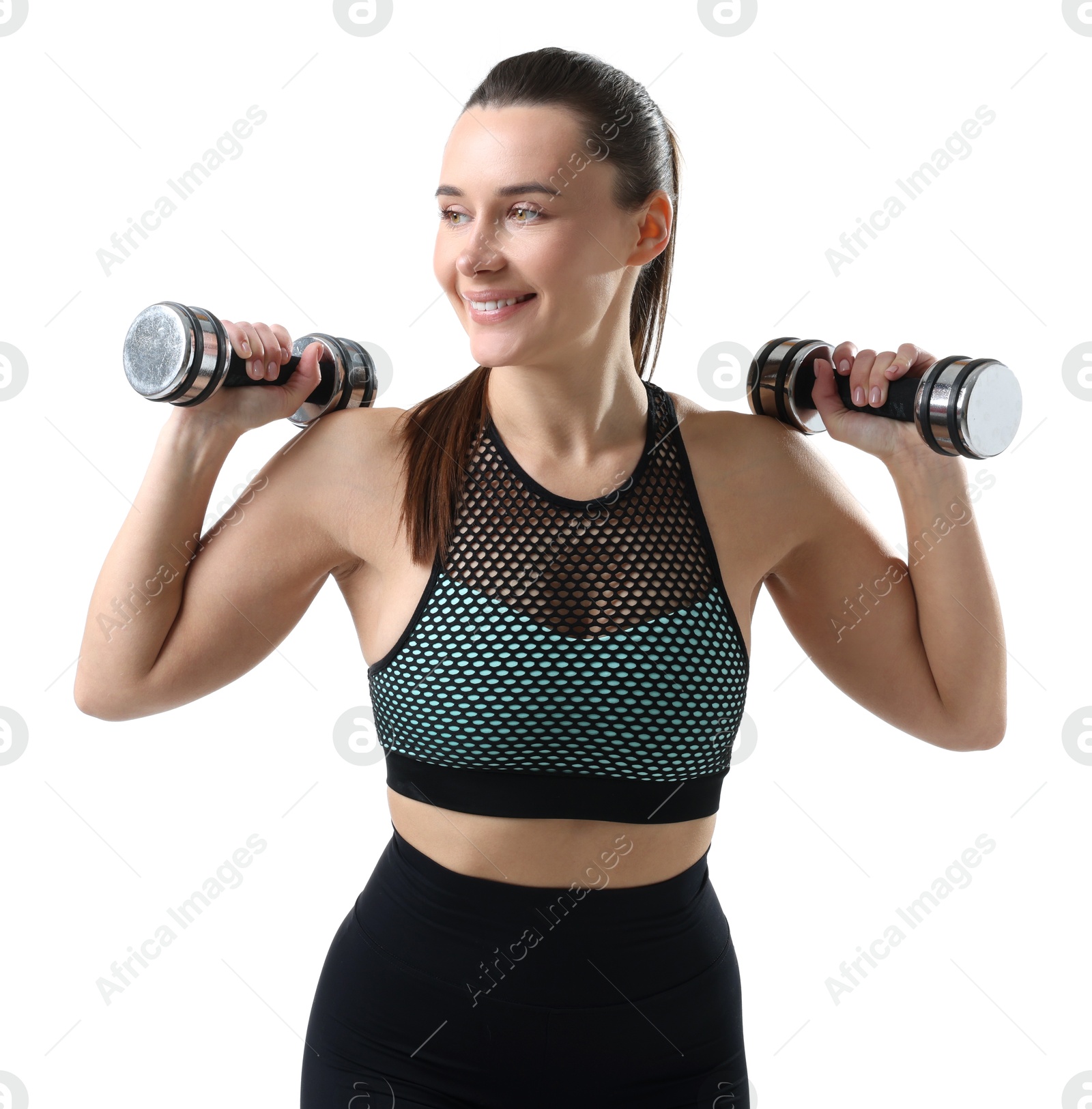 Photo of Smiling woman in sportswear training with dumbbells on white background