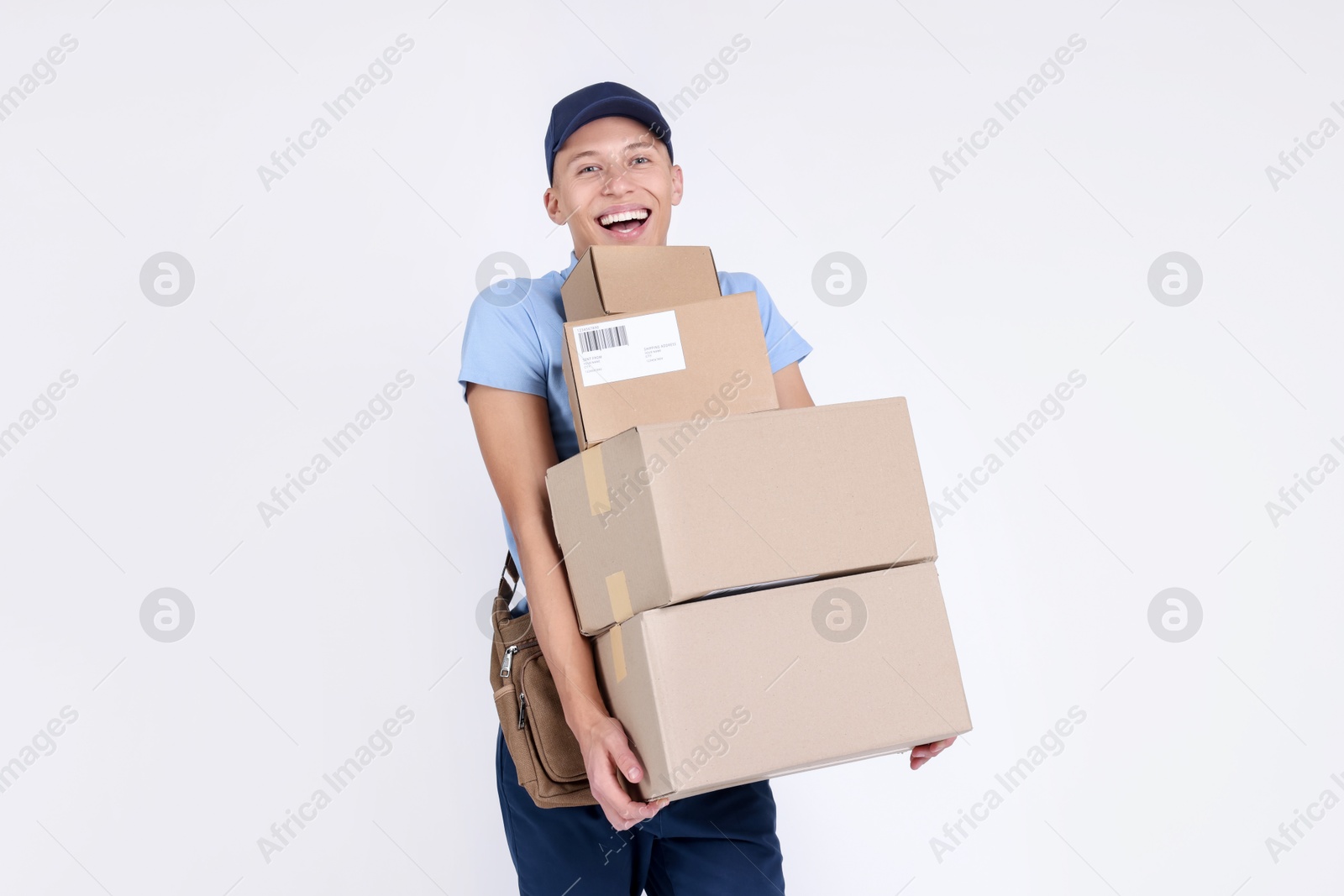 Photo of Happy postman with parcels on white background