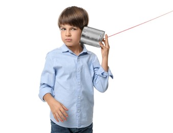 Boy using tin can telephone on white background