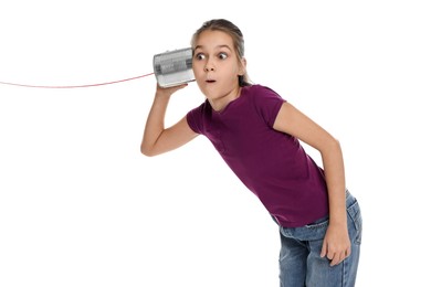 Girl using tin can telephone on white background