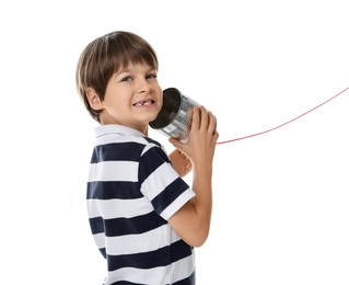 Boy using tin can telephone on white background