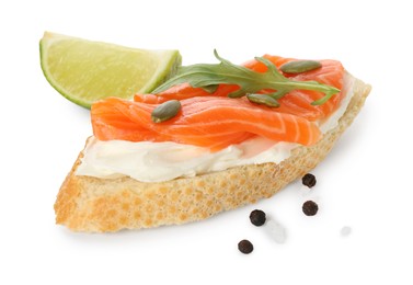 Photo of Delicious bruschetta with cream cheese, salmon and piece of lime isolated on white