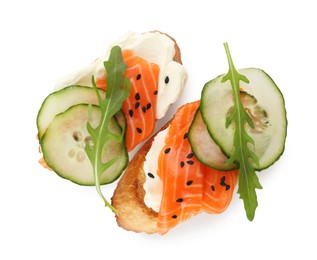 Photo of Delicious bruschette with cream cheese, salmon and cucumber isolated on white, top view