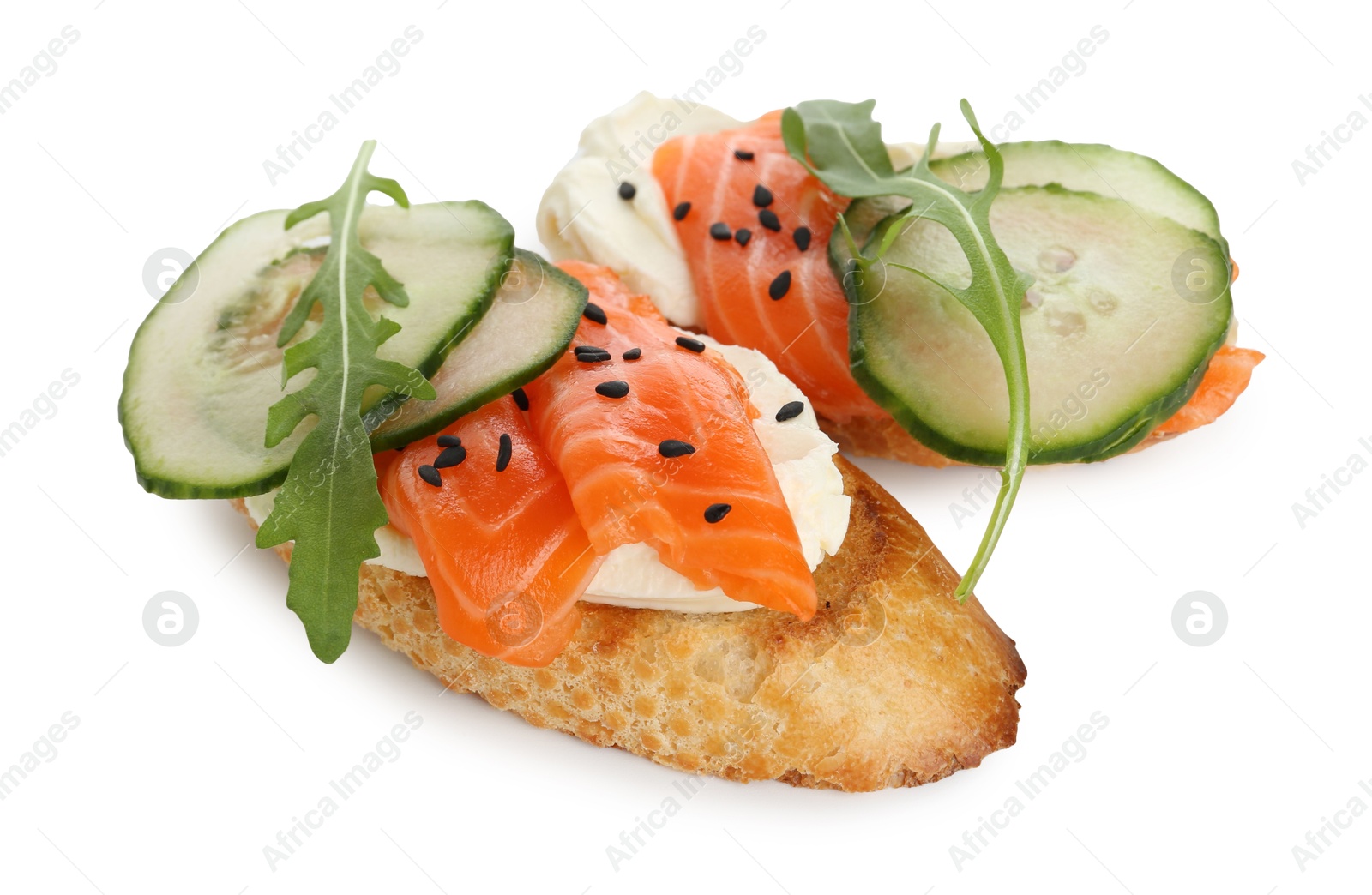 Photo of Delicious bruschette with cream cheese, salmon and cucumber isolated on white