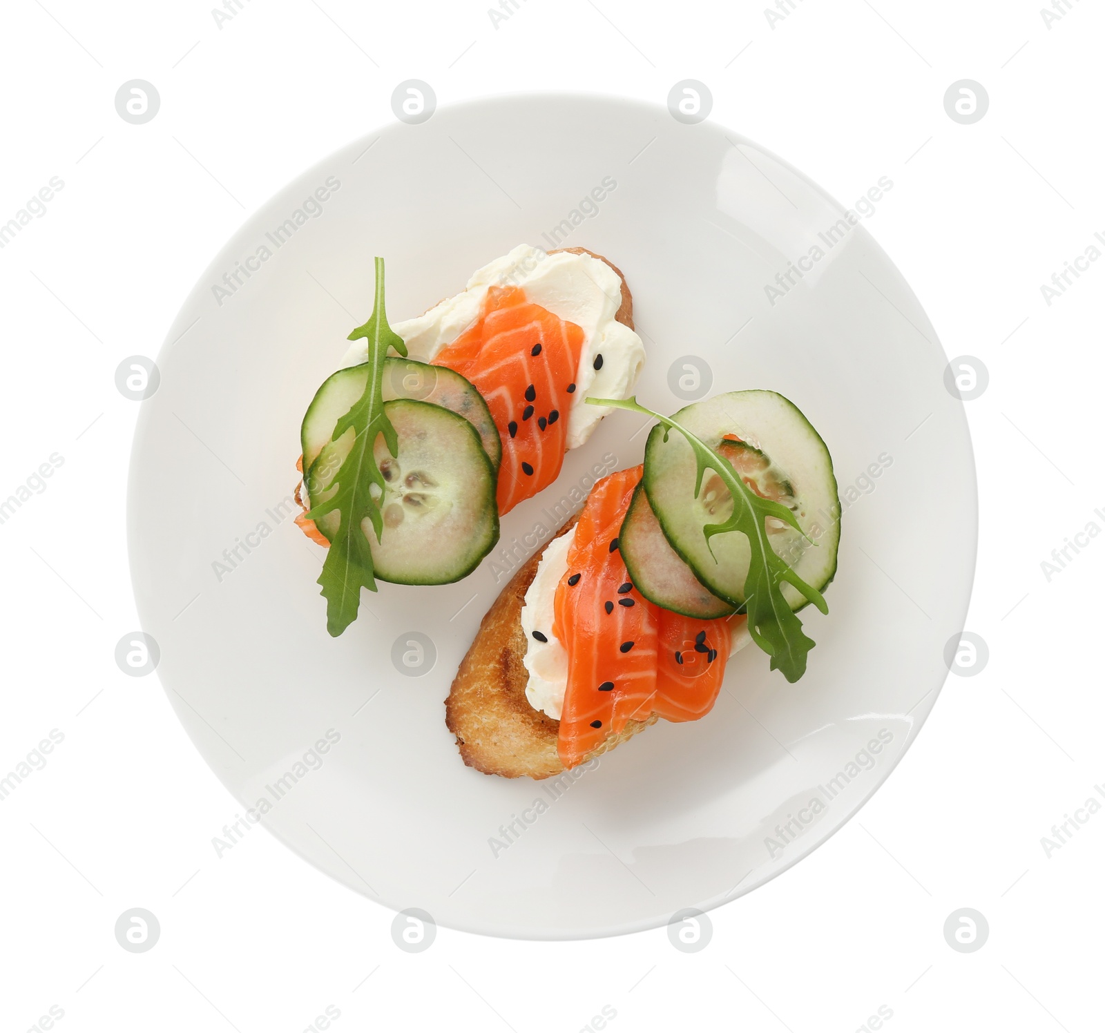 Photo of Delicious bruschette with cream cheese, salmon and cucumber isolated on white, top view