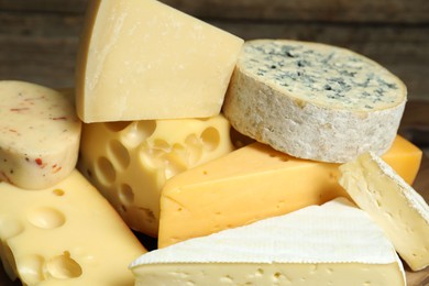 Photo of Different types of cheese on blurred background, closeup