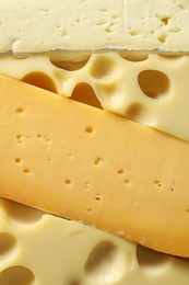 Photo of Different types of cheese as background, closeup