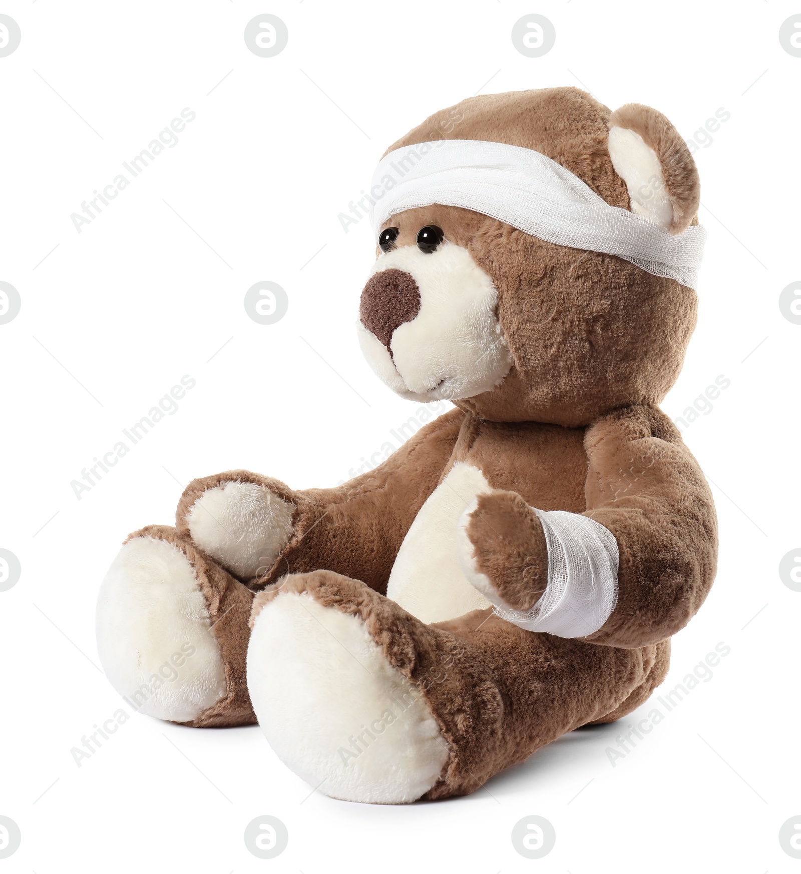 Photo of Teddy bear with bandages isolated on white