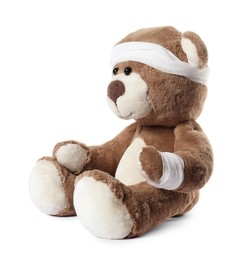 Photo of Teddy bear with bandages isolated on white