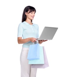 Photo of Internet shopping. Happy woman with laptop and colorful bags on white background