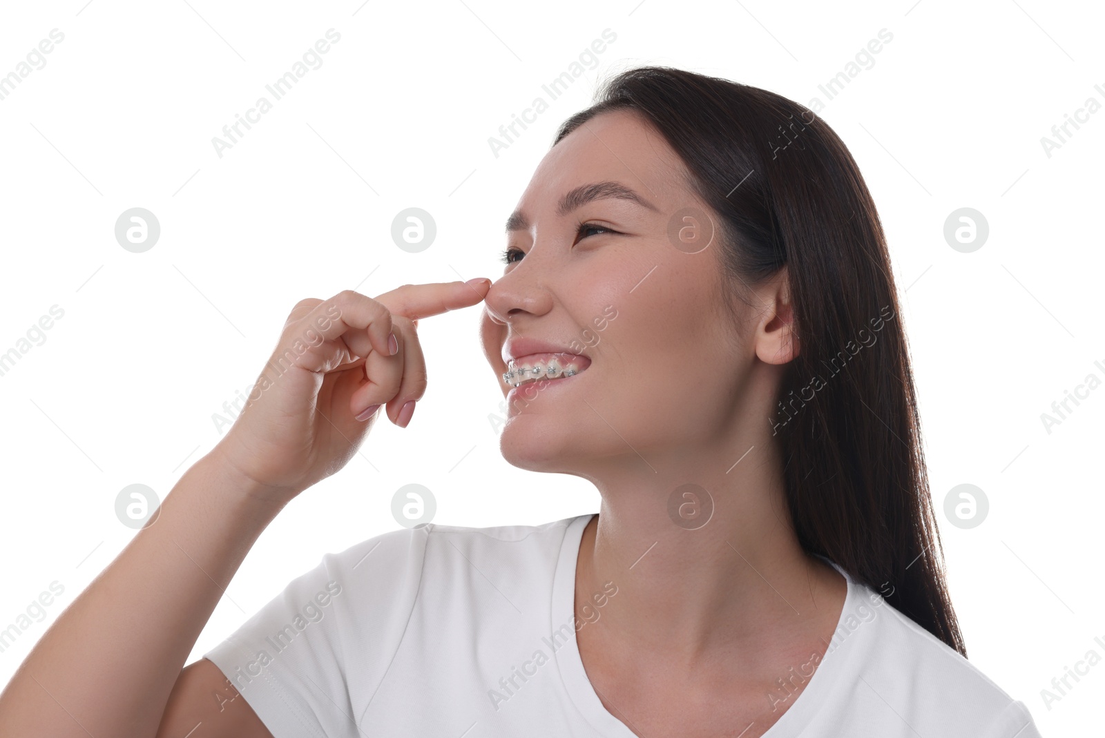 Photo of Young woman touching her nose on white background