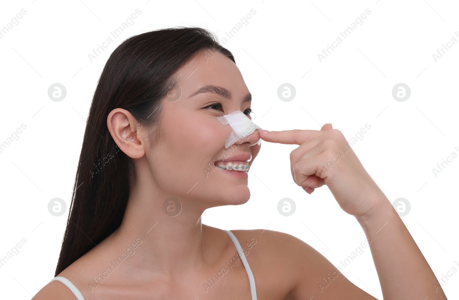 Photo of Woman with medical bandage on her nose after plastic surgery operation against white background