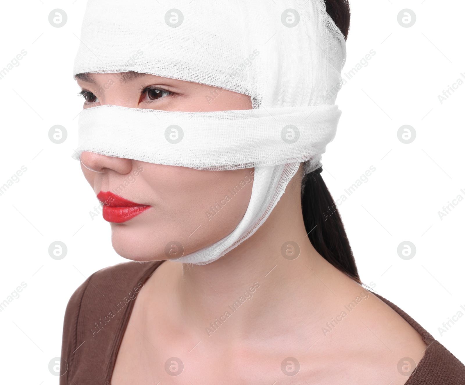 Photo of Woman with nose wrapped in medical bandage after plastic surgery operation on white background, closeup