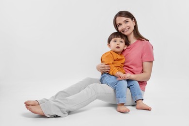 Photo of Happy mother with her cute little son on white background