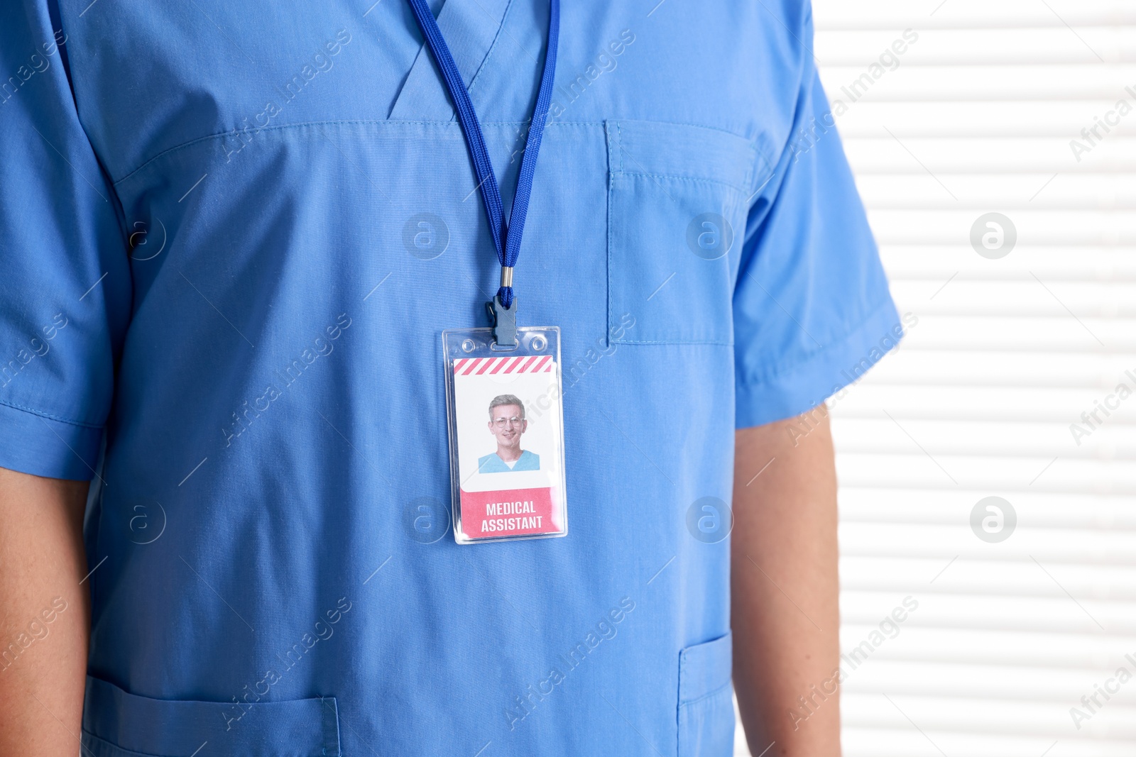 Photo of Medical assistant with badge on white background, closeup